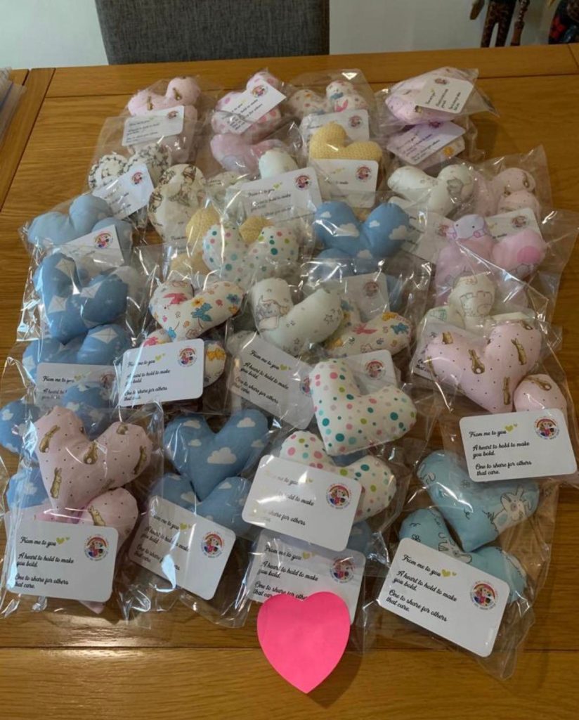 a collection of hand stitched hearts in various shades of colour for Children's Hospital Pyjamas charity -each heart is gifted with pyjamas.